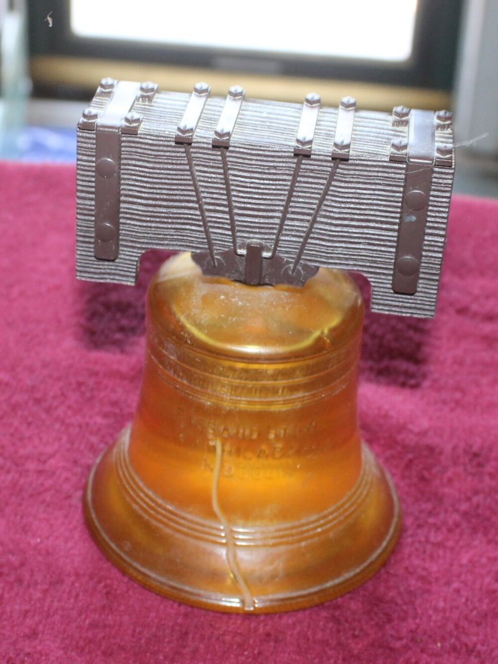 Vintage Avon Liberty Bell decanter, crafted from amber-colored glass